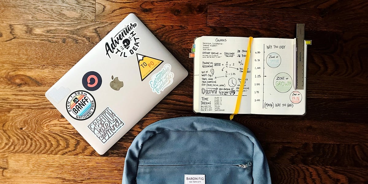 computer-notebook-and-backpack-on-the-table